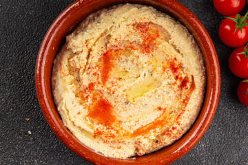 Hummus chickpea dip tasty appetizer vegetable dish fresh gourmet vegetarian and vegan food background on the table rustic food top view copy space