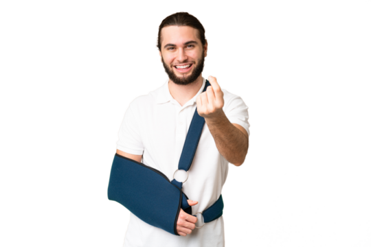 Young handsome man with broken arm and wearing a sling over isolated chroma key background making money gesture