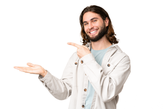 Young handsome man over isolated chroma key background holding copyspace imaginary on the palm to insert an ad