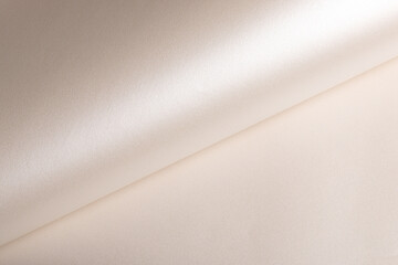 Background with satin paper texture. Rolled surface with glossy pearlescent finish, champagne and...