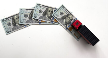  USD dollar bills, a trailer truck , depicts wasting time and paying a lot of money to buy things...