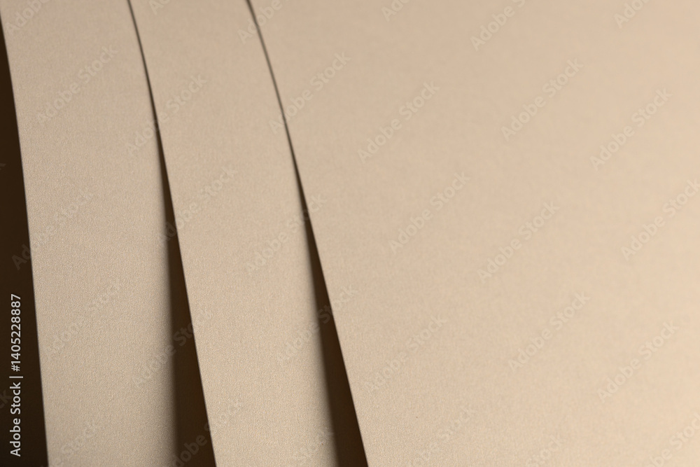 Poster paper background with matte texture. layered smooth sheets in beige, light brown, and golden tones, 
