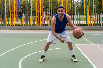 Obraz premium Basketball Player Dribbling on Outdoor Court