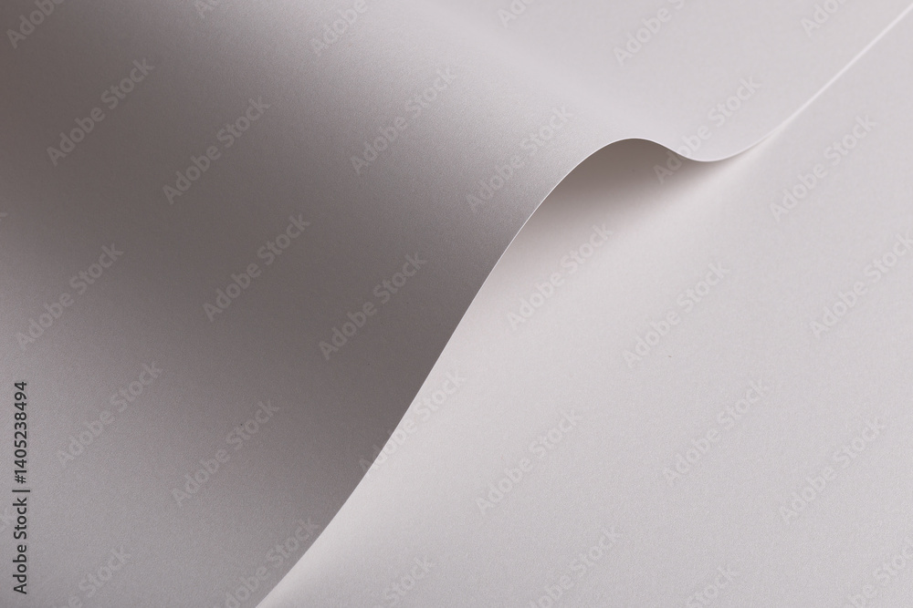 Poster pearl satin paper background with a glossy, smooth texture and graceful curved folds. pale grey and 