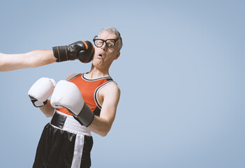 Nerdy boxer getting punched on his face
