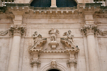 Statues of angels above the arched entrance of the Church of St. Blaise. Dubrovnik, Croatia