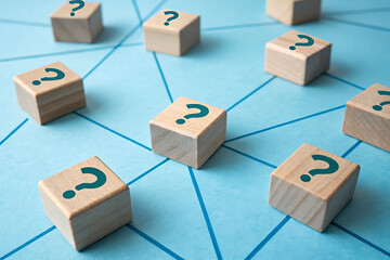 Wooden blocks with question marks on a blue background symbolize curiosity and seeking answers in learning and exploration