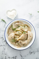 Traditional dumplings served with dill and sour cream