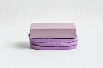 Purple Rectangle on Looped Fabric. A minimalist composition features a rectangular shape resting upon a loop of vibrant, purple fabric, set against a pristine white background.
