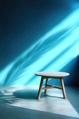 An empty table positioned near a calming blue backdrop, displaying unique light patterns and shadows. Perfect for highlighting summer-inspired displays, brand promotions, beauty products, and culinar