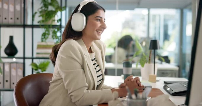 Headphones, computer and businesswoman in office with energy for creative project listening to music. Dancing, audio tech and female critic editor working online with streaming album for review.