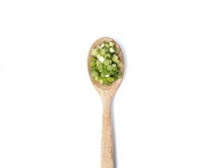 Fresh leek slices on wooden spoon isolated on white background, Food ingredient