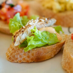 Close up of bruschetta with lettuce and grilled chicken