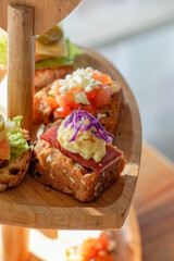 Assorted Bruschetta's on wooden tray