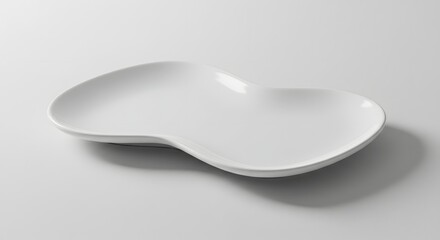 A minimalist view of an empty white plate on a white surface with soft lighting and shadows casted