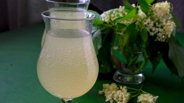 Pure carbonated elderflower drink. Flower summer kvass in glasses. Sparkling homemade water Buza