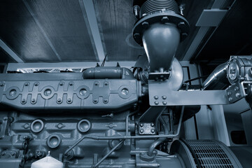 A large engine with a black and silver color. The engine is made of metal