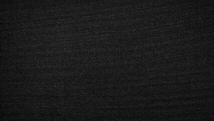 A black background with no visible objects. The background is very dark and has a lot of texture