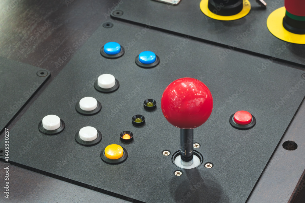 Fototapete A red button with a white circle in the middle. There are many buttons on the table.