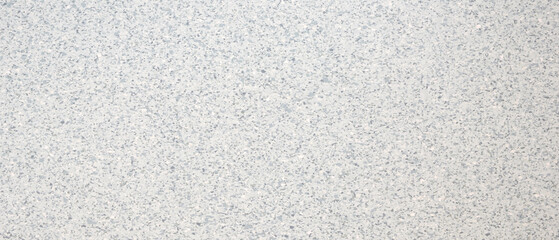 White wall with a pattern of small dots as an abstract textured background. The dots are evenly...