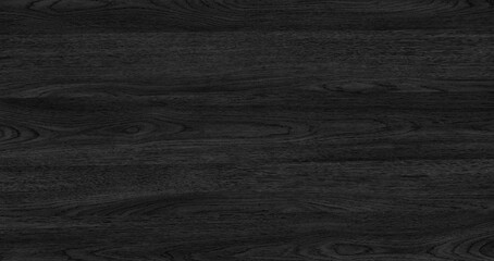 A black abstract wooden texture surface background with a grain pattern. The surface is dark and...