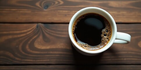 Dark roast coffee in white ceramic mug, top view, cafe, still life, latte