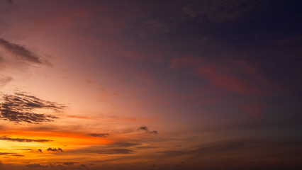 Dusk sky on twilight after sundown with horizon orange, red sunlight sunset clouds in golden hour and dark blue sky background