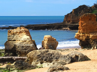 Algarve beach at Olhos de Agua with red cliffs at the coast