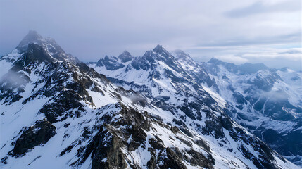 Obraz premium Snow Covered Mountain Peaks at Sunrise, Ideal for Meditation, Scenic Presentations, Website Backgrounds, and Calm Nature Visuals