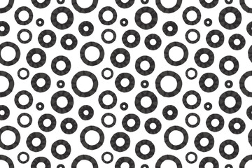 Seamless pattern featuring black rings of various sizes on a light background. Geometric, monochrome design with an industrial vibe. Vector illustration EPS10.