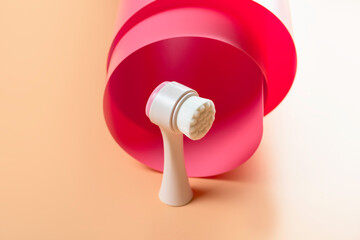 Brush for washing and cleansing the face. Hygienic device. Female beauty.
