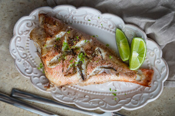 Baked sea bass with herbs and lime