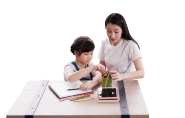 Smiling Asian mother and daughter drawing with color pencil on wooden table together at home. Child educational for homeschooling concept