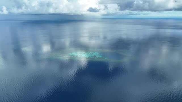 Calm, serene seas surround a remote atoll in the Togian Islands of Central Sulawesi, Indonesia. This beautiful equatorial region is known for its extraordinary marine biodiversity.