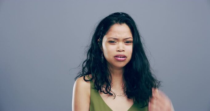 Woman, crying face or nervous in depression, anxiety and mental illness with stress by gray background. Young, mexico person or portrait for fear, frustrated or grief in broken heart in studio mockup