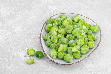 Frozen Brussels sprout in trendy plate. Healthy ingredient for cooking vegan food
