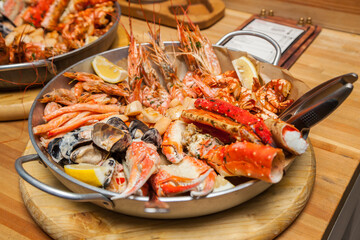 A plate with juicy grilled crabs, shrimp, mussels, and red fish