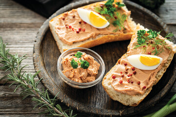 Fresh homemade chicken liver pate on baguette with fresh parsley and spices