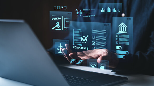 Digital compliance and data regulation concept with holographic interface above hands near laptop on dark blue creative background..