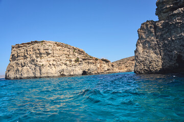 Rocky cliffs at crystal lagoon on European Comino island in Malta