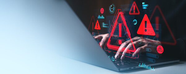 Cybersecurity warning concept with hacker hands on laptop and digital red alert symbols on creative...