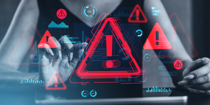 Cybersecurity warning concept with red alert icons and data graphics on transparent futuristic screen interface over digital background.