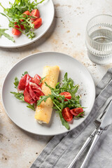 Delicious french omelette with cheese served with fresh vegetables and ham. Healthy diet food concept