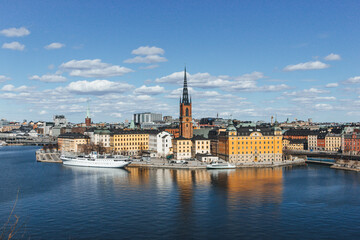 Fototapeta premium panorama of stockholm on beautiful sunny day with water reflections and clouds