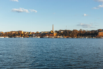 Fototapeta premium view of the old town of stockholm at sunset with sea waters blue and clear sky
