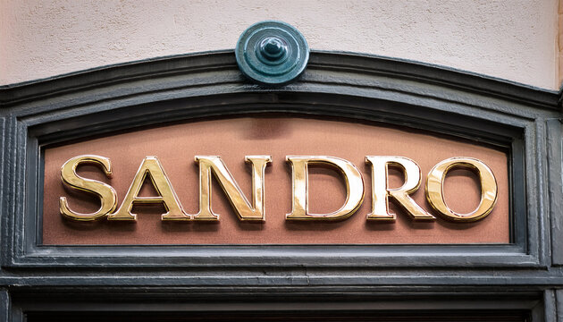 sandro sign text shop and logo brand store chain on wall facade entrance on fashion clothing