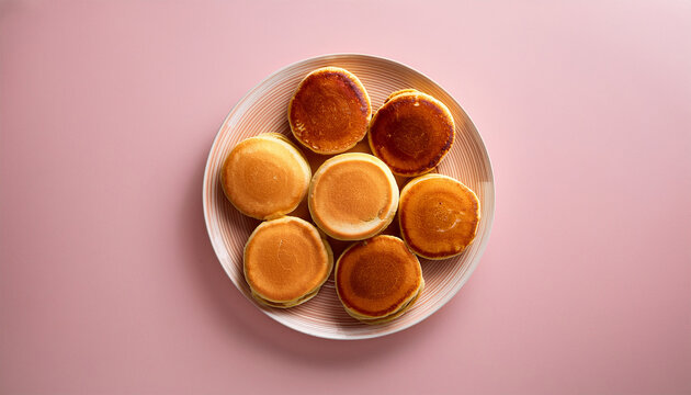 pankakes on russian plate isolated on light pink background