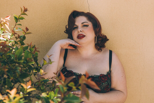 Plus size old Hollywood lingerie model outdoors