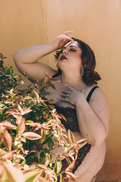 Plus size old Hollywood lingerie model outdoors