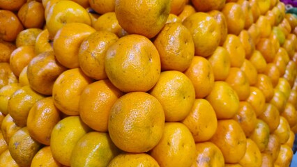 Pile of fresh citrus fruits for creative background and texture design. pile of orange fruit at market. top view. close up orange.
